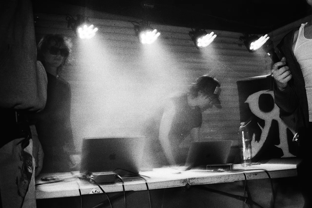 Black-and-white photograph of a hazy live music performance